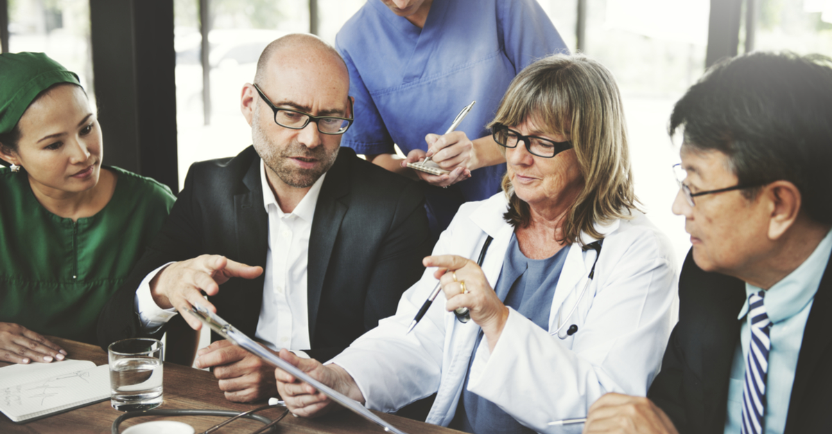 medical professionals reviewing digital documents