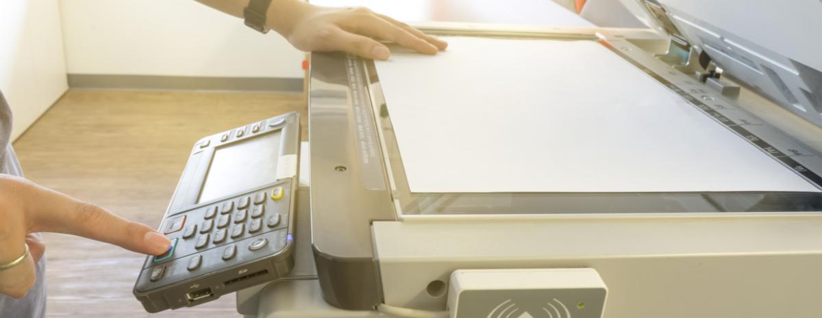 person scanning a document with office scanner