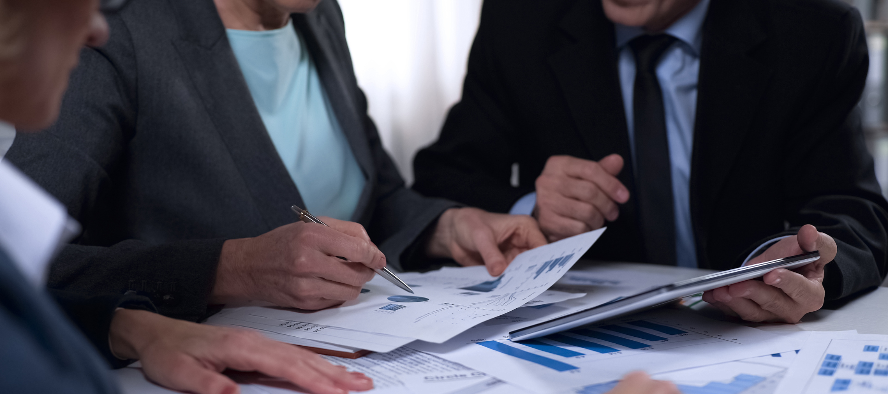 Local government workers or employees going over documents at a conference table