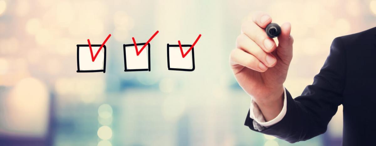 hand writing a checklist on a screen