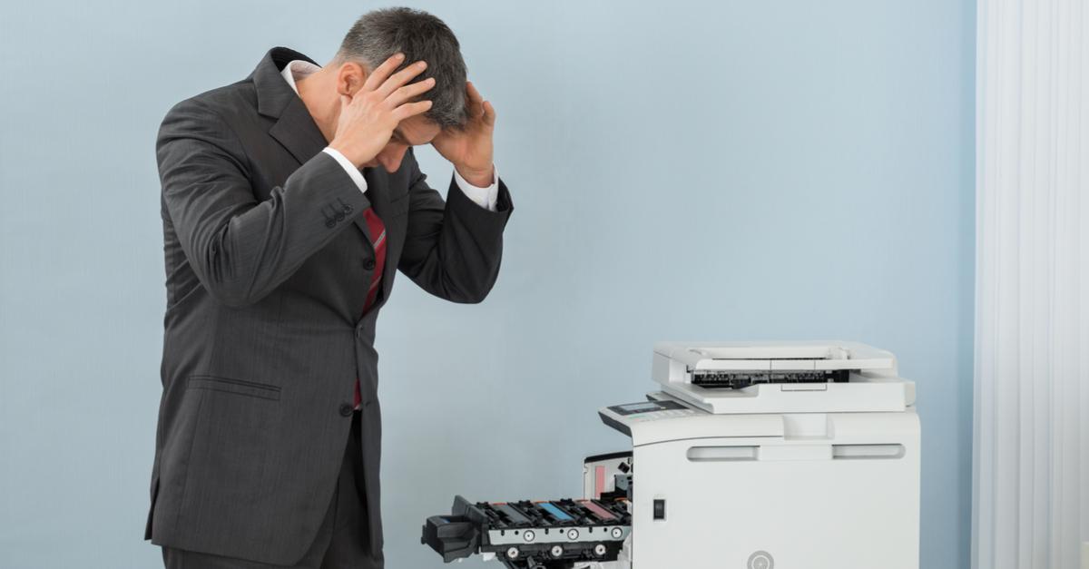man frustrated with his office printer