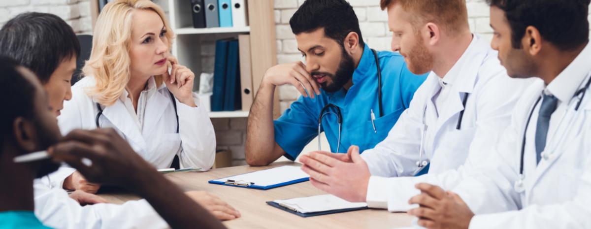 healthcare workers in a meeting reviewing digital documents