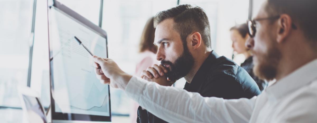 IT management team looking at pc