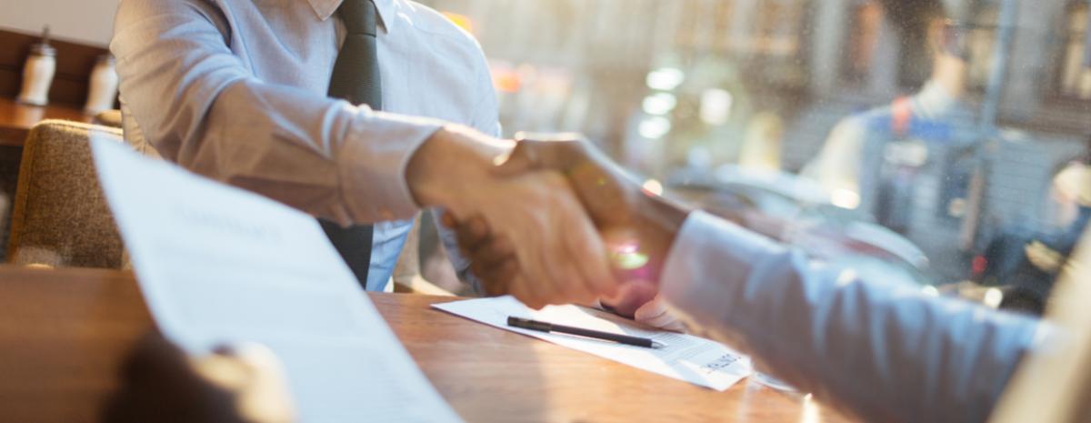 shaking hands over a copier lease agreement