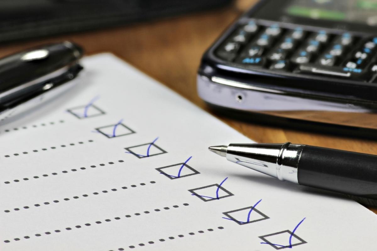 black pen marking a checklist