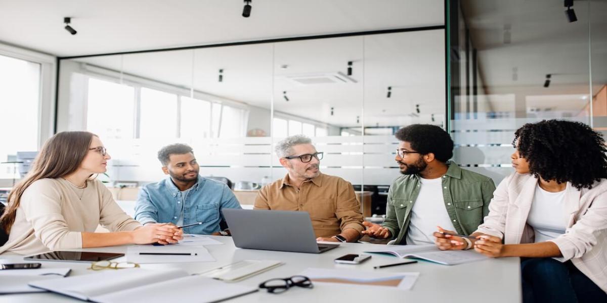 Business leaders reviewing IT strategy and performance metrics in a modern office