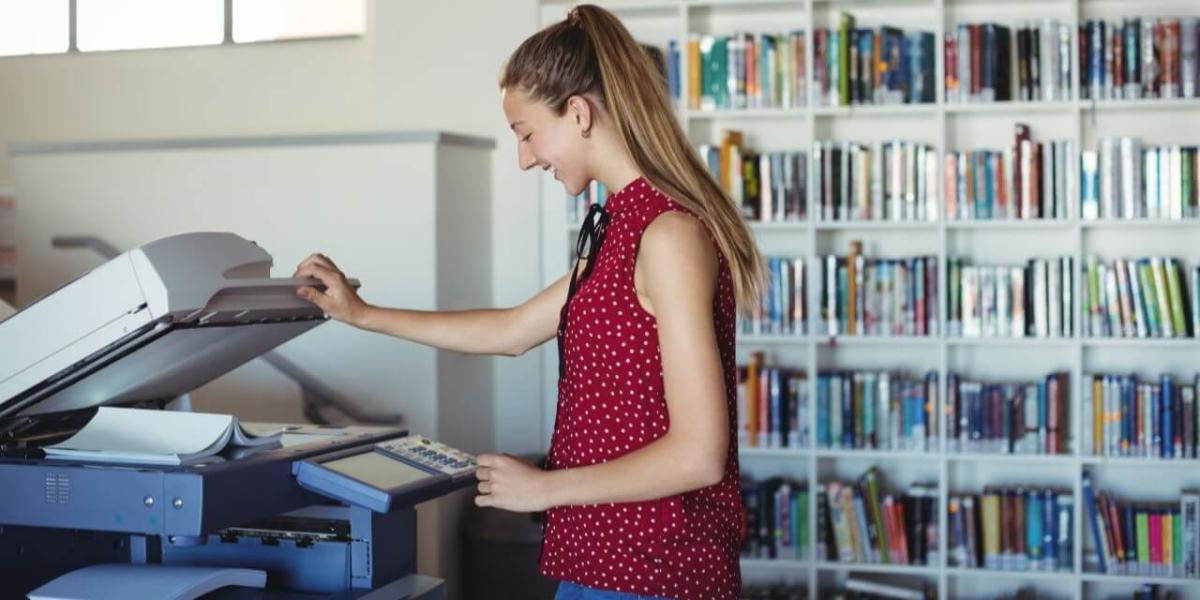 School employee printing assignments off of a printer