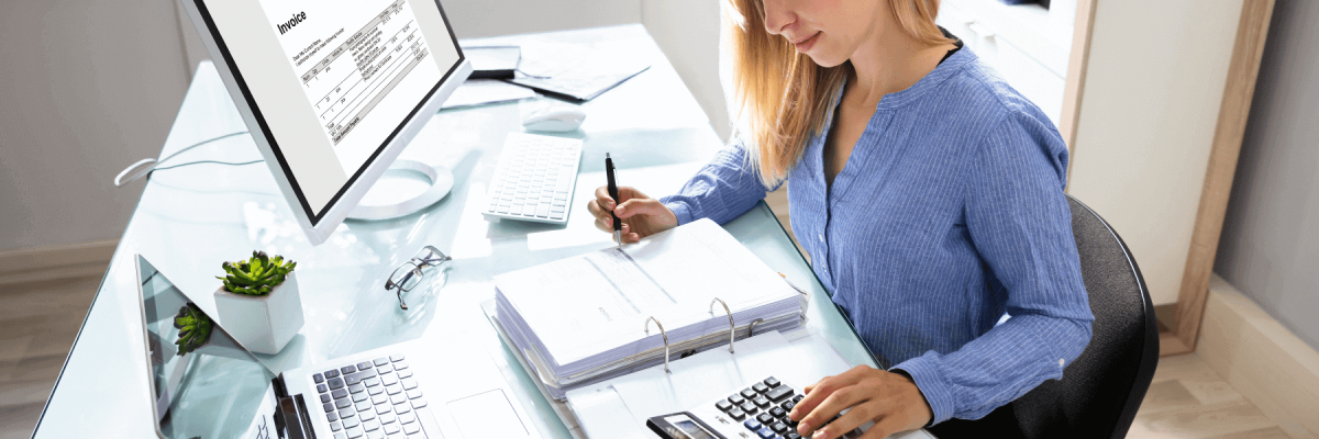 female accountant using computer and calculator 