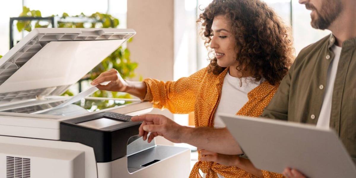 A professional office setting with a multifunction copier being used by employees or reviewed by an office manager