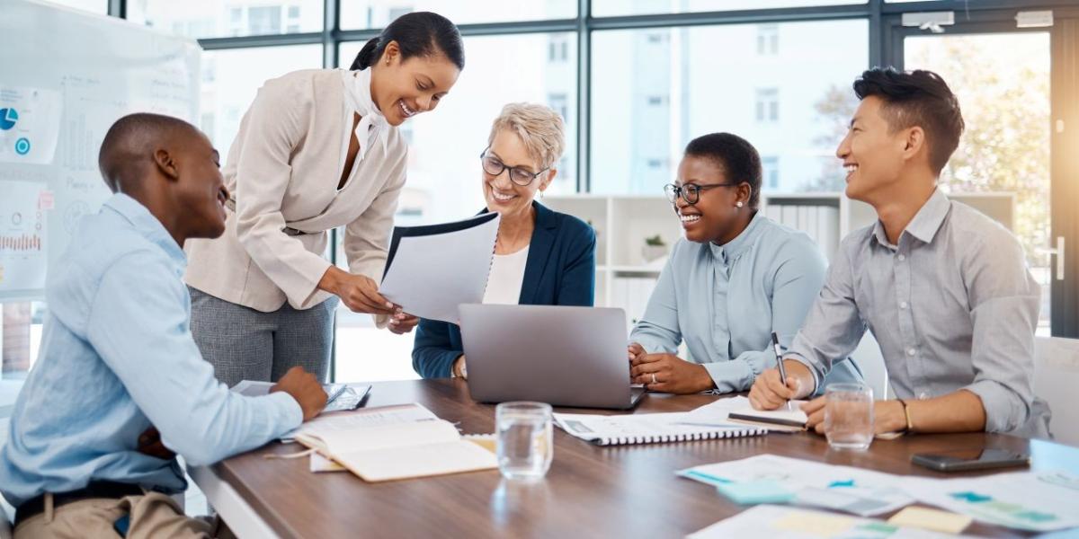 Business leaders reviewing IT strategy and performance metrics in a modern office